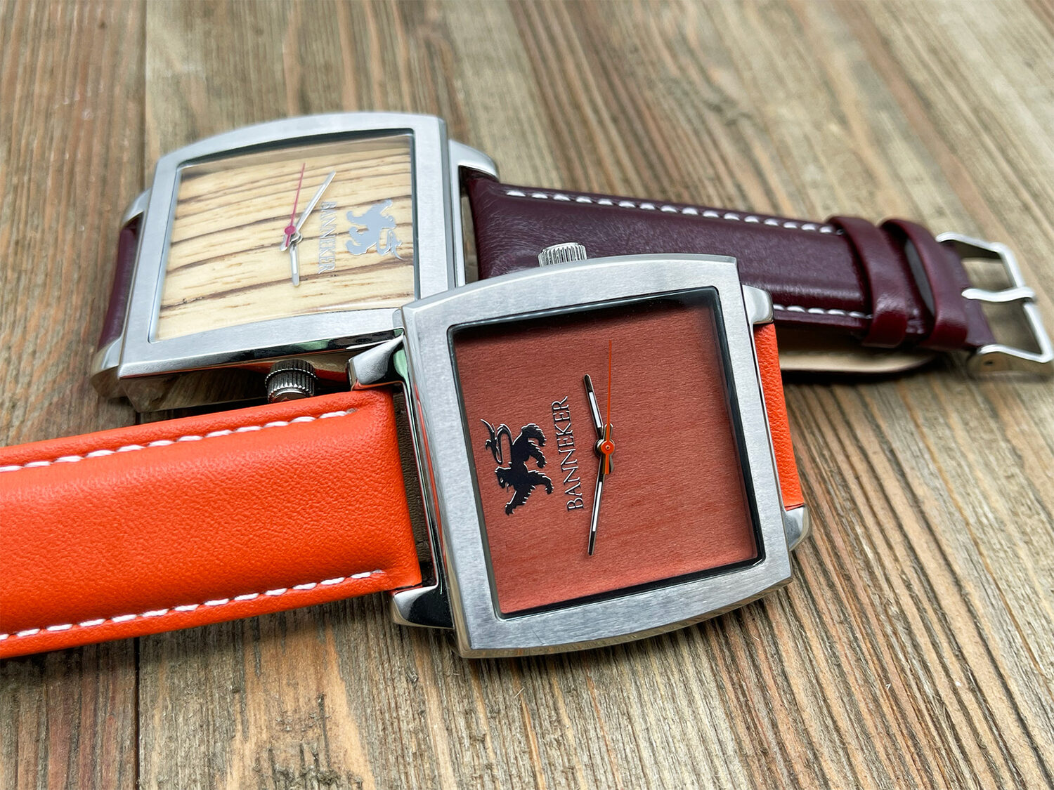 Two Banneker square wood-faced watches in burnt orange and burgundy
