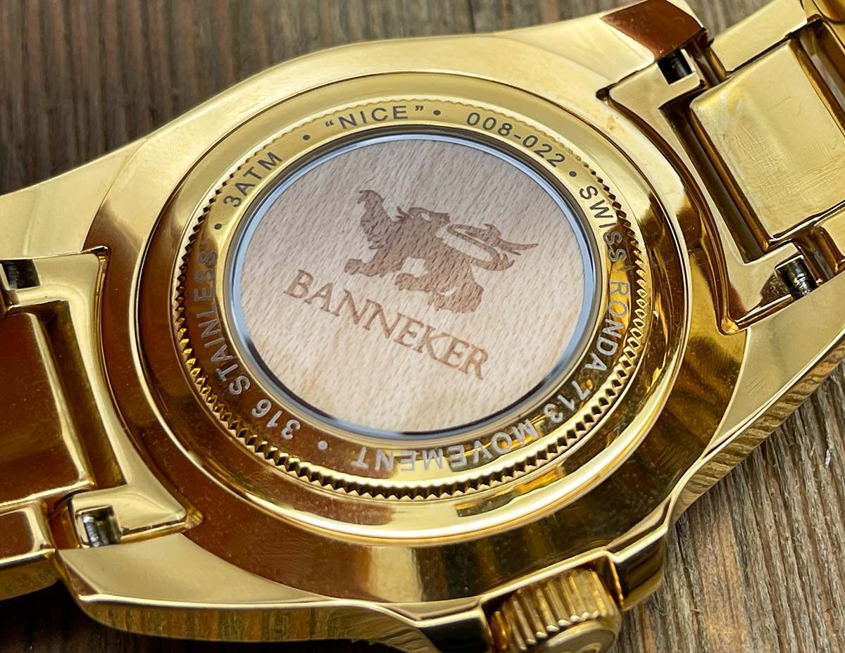 Engraved gold Banneker caseback on wood — Swiss Ronda movement, 316 stainless steel
