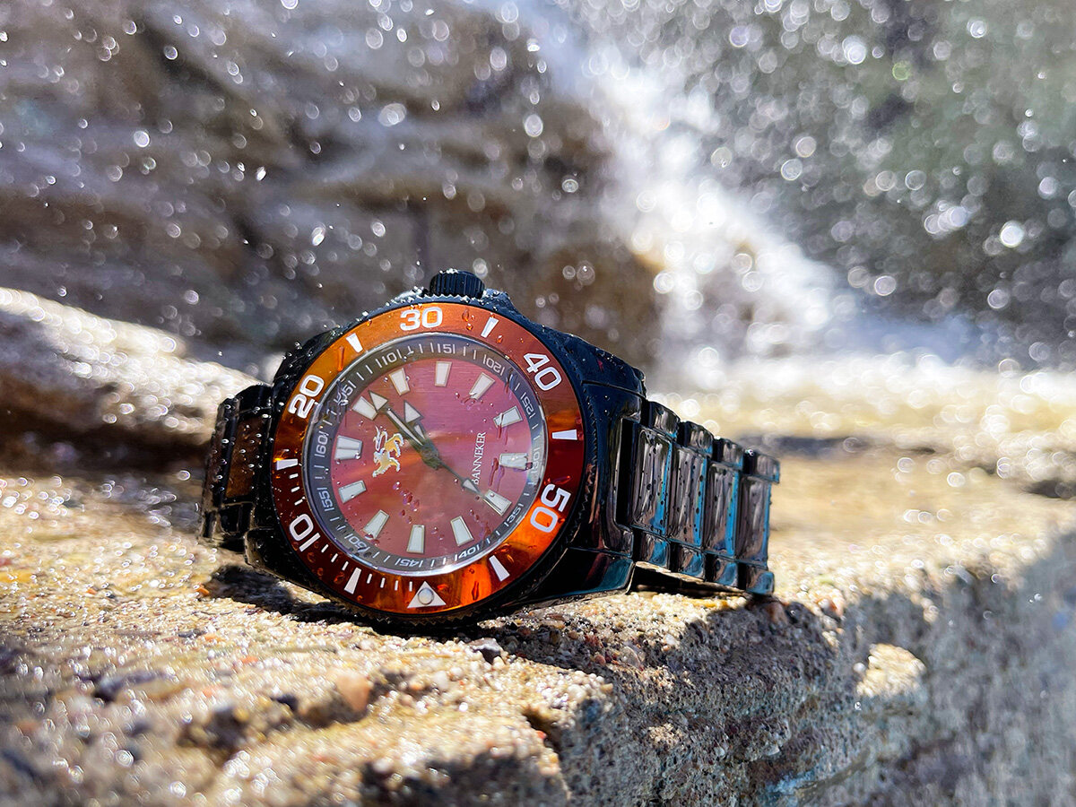 A Banneker crimson wood-faced diver watch by a waterfall