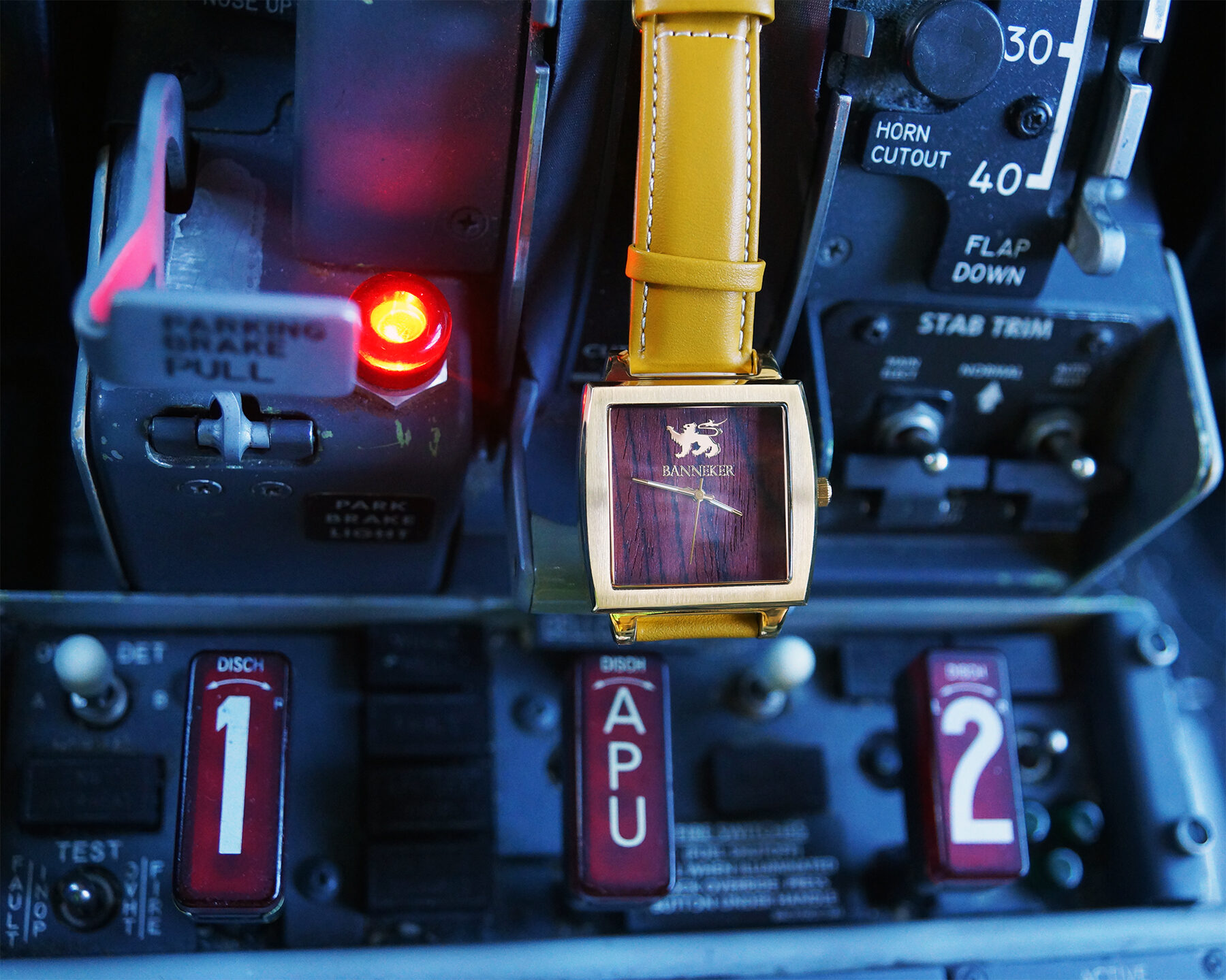 A Banneker wood-faced watch resting in an aircraft cockpit